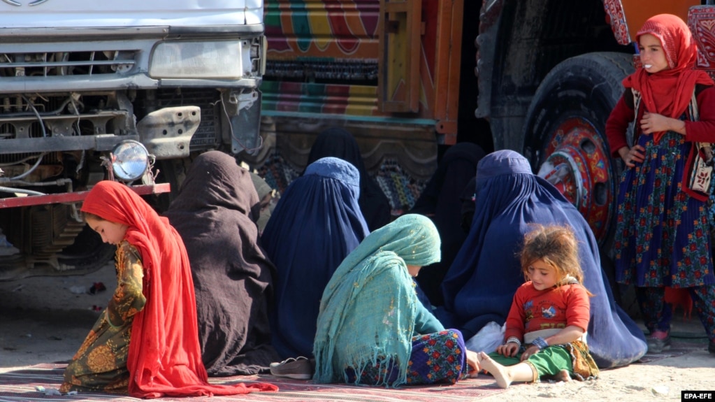 Afghan refugee women and children sit at a registration center after arriving back from Pakistan in Kandahar Province, Afghanistan, late last year. 