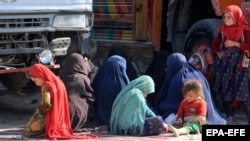 Afghan refugee women and children sit at a registration center after arriving back from Pakistan in Kandahar Province, Afghanistan, late last year. 