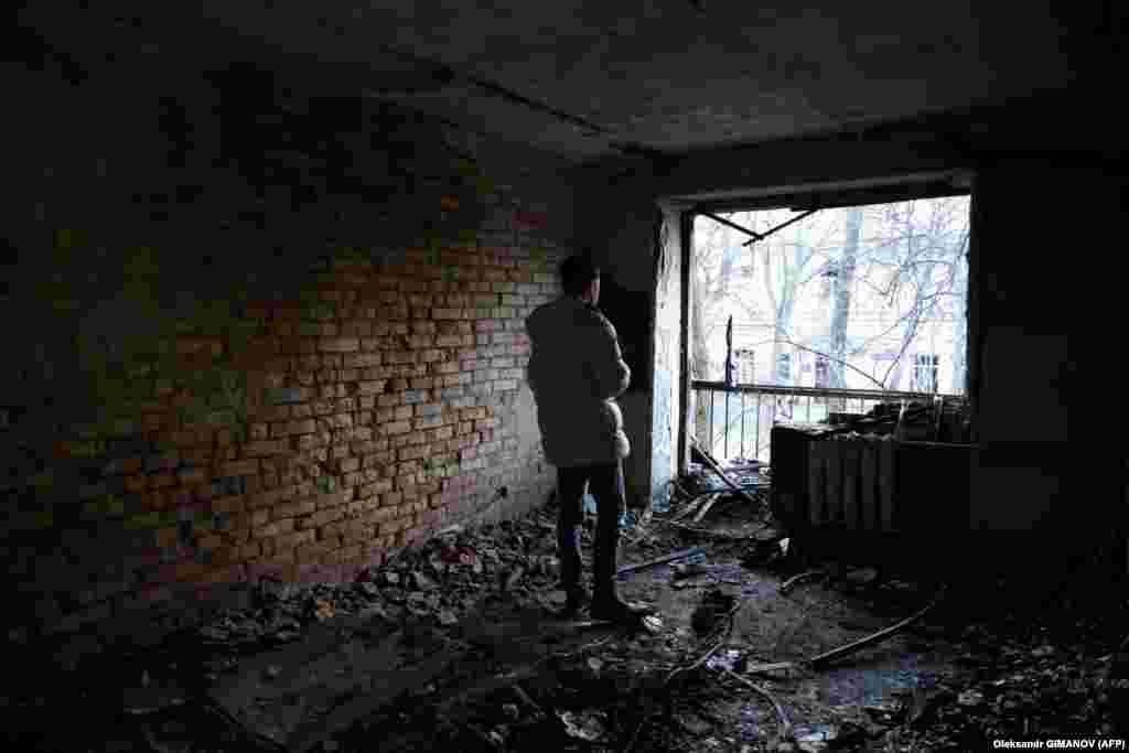 A resident inspects a destroyed apartment in Odesa.