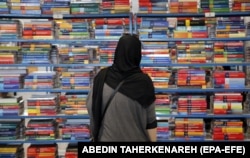 A woman browses at the Tehran International Book Fair at Imam Khomeini Mosque in Tehran in May 2024. This year, only the virtual expo is taking place.