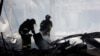 Ukrainian emergency workers search the site of a Russian missile attack on a supermarket in Kostyantynivka in the Donetsk region on August 9. 