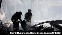 Ukrainian emergency workers search the site of a Russian missile attack on a supermarket in Kostyantynivka in the Donetsk region on August 9. 