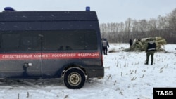 Investigators at the crash site where a Russian Il-76 plane came down near Belgorod on January 24. 