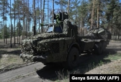 Ukrainian servicemen of the 45th Artillery Brigade drive a Swedish-made self-propelled Archer howitzer in the Donetsk region on May 7.