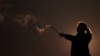 IRAN-WOMEN/PROTEST --An Iranian woman lights a firework during the Wednesday Fire celebration (Chaharshanbeh Suri in Persian) at a park in Tehran, Iran March 14, 2023.