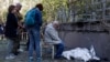 Relatives mourn near the body of a child killed during after a Russian strike on Kyiv earlier this month. 