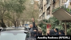 Ulvi Hasanli is shown being detained on November 20. He says he was beaten while in custody and that, during his questioning, he was asked why Abzas chose to cover corruption rather than Azerbaijan's military successes.