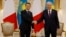 French President Emmanuel Macron (left) shakes hands with his Kazakh counterpart, Qasym-Zhomart Tokaev, in Astana on November 1.
