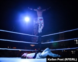 A competitor who goes by the name Hantry jumps off the ropes as his rival lies prone on the mat in Kyiv.