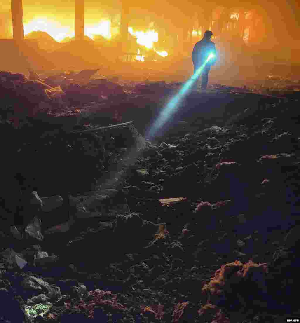 Ukrainian rescuers work at the site of an overnight attack on the outskirts of Odesa, Ukraine, on May 8.