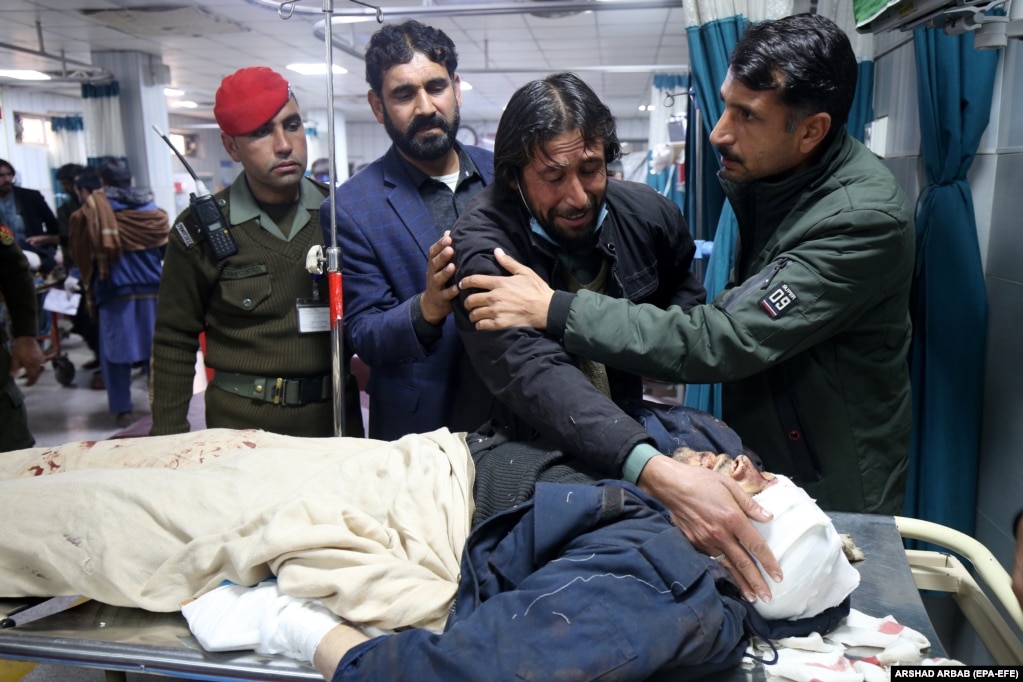 A relative caresses the face of a victim after he succumbed to his injuries following a roadside bombing that targeted a police vehicle near the Afghan border in Bajaur,&nbsp;a tribal district in Pakistan&#39;s Khyber Pakhtunkhwa Province, on January 8. The Tehrik-e Taliban Pakistan (TTP) militant group claimed responsibility for the blast, which killed at least seven people. Three police officers remain in critical condition.