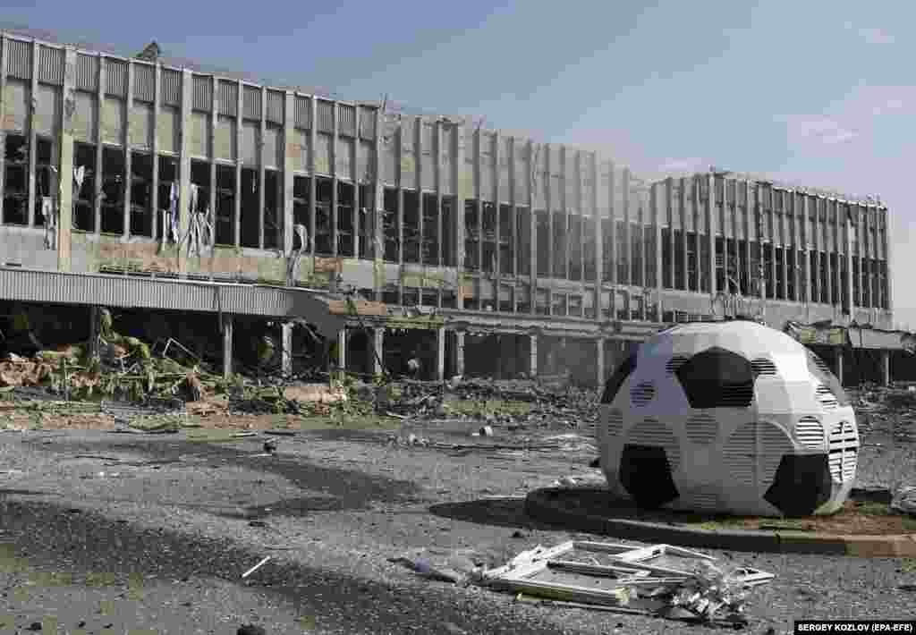 Ukrainian rescuers work at the site of a rocket strike on a sports complex in Kharkiv, northeastern Ukraine, on September 1.