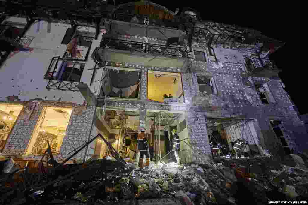 Ukrainian rescue personnel work at the site of a Russian missile attack on a hotel in Kharkiv late on January 10 that wounded 11 people, according to local authorities. The strike comes just weeks ahead of the war&#39;s second anniversary, with both Moscow and Kyiv accusing each other of inflicting civilian casualties in a sharp escalation of attacks.