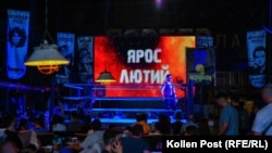 Yaros Lyutiy's name appears onscreen at a pro wrestling event in Kyiv.