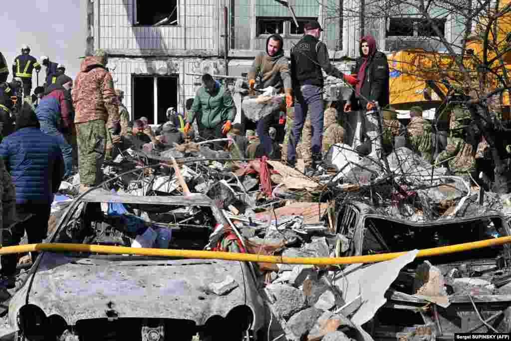 Rescuers and residents search for survivors in the rubble in Uman.