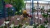 Flowers and toys are placed for the victims near the Vladislav Ribnikar school in Belgrade on May 4, 2023.