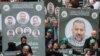 Transparenti sa fotografijama likova zamjenika Hamasa, Selaha Arourija koji je ubijen u eksploziji u Bejrutu, tokom njegove sahrane, Libanon 4. januar 2024. 