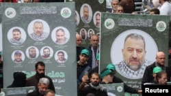 Transparenti sa fotografijama likova zamjenika Hamasa, Selaha Arourija koji je ubijen u eksploziji u Bejrutu, tokom njegove sahrane, Libanon 4. januar 2024. 