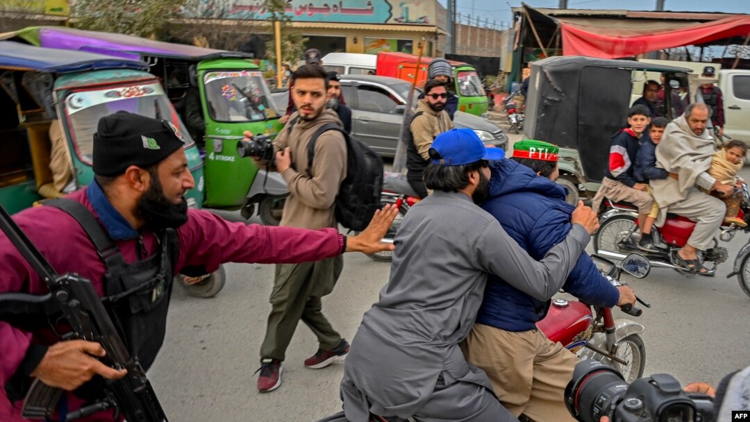Police detain PTI supporters during a protest demanding the release of party leader Imran Khan in Peshawar on January 28.