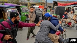 Police detain PTI supporters during a protest demanding the release of party leader Imran Khan in Peshawar on January 28.