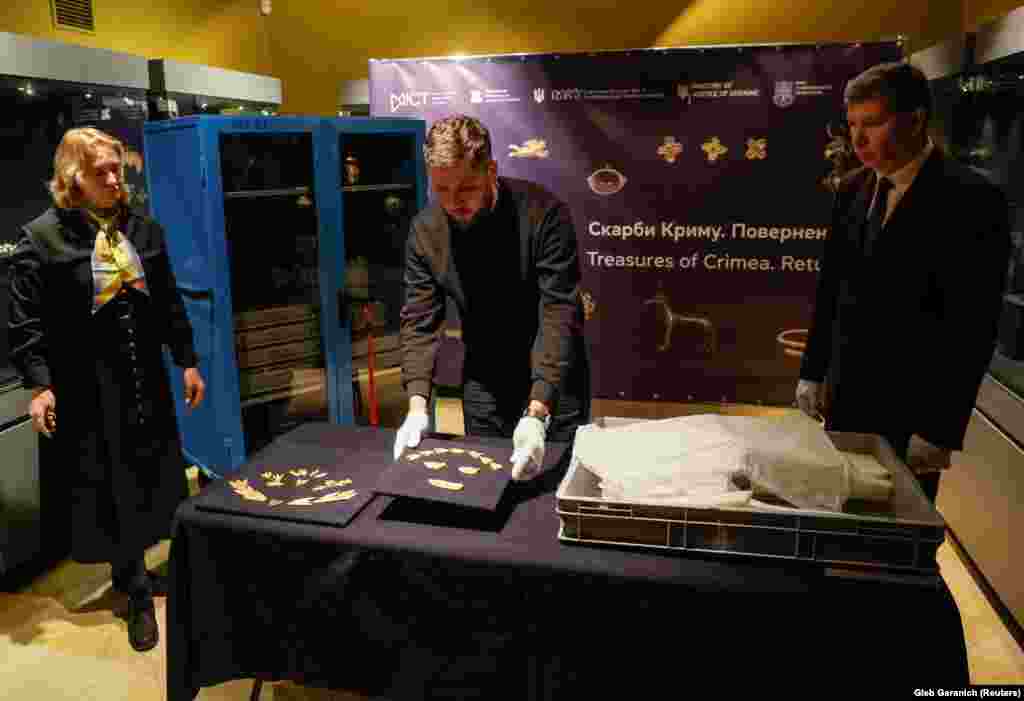 An expert from the National Museum of History of Ukraine unpacks a box in Kyiv containing ancient artifacts from Crimea on November 28. The transfer of hundreds of artifacts, known as the Scythian gold, marks the end of a protracted legal battle over ownership rights between Ukraine and the museums located in the Moscow-controlled territory.