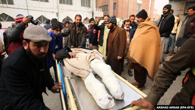 An injured man is shifted to a hospital to receive medical treatment following a blast that targeted a police vehicle near the Afghan border in the Bajaur district of Khyber Pakhtunkhwa on January 8.