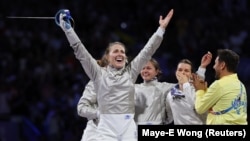 Olha Kharlan celebrates as Ukraine wins the women's team saber fencing event at the Paris Olympics on August 3. 
