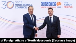 Macedonian Foreign Minister Bujar Osmani (right) welcomes his Russian counterpart, Sergei Lavrov, to the OSCE summit in Skopje on November 30.