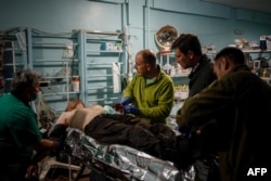 Military medics give first aid to a wounded Ukrainian serviceman at a frontline medical stabilization point near the city of Bakhmut in the Donetsk region earlier this year.