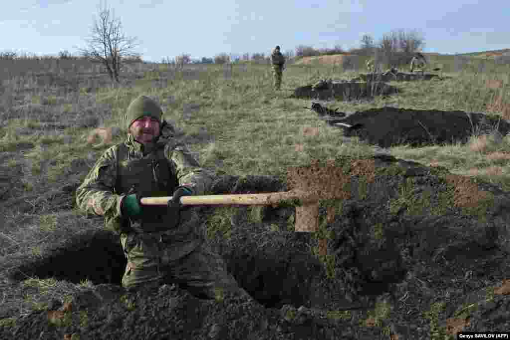 Ukrainian soldiers of the 42nd Mechanized Brigade dig trenches during a field military exercise in the Donetsk region.