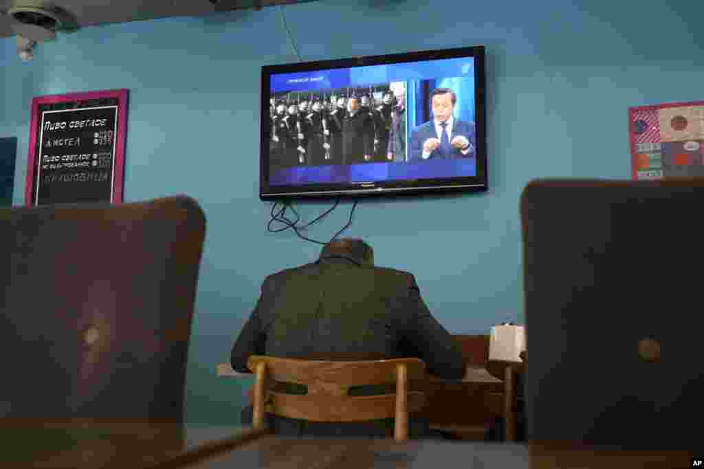 &nbsp;A TV screen at a cafe in St. Petersburg displays Chinese President Xi Jinping attending an official welcome ceremony upon his arrival in Russia for a state visit on March 20.&nbsp;