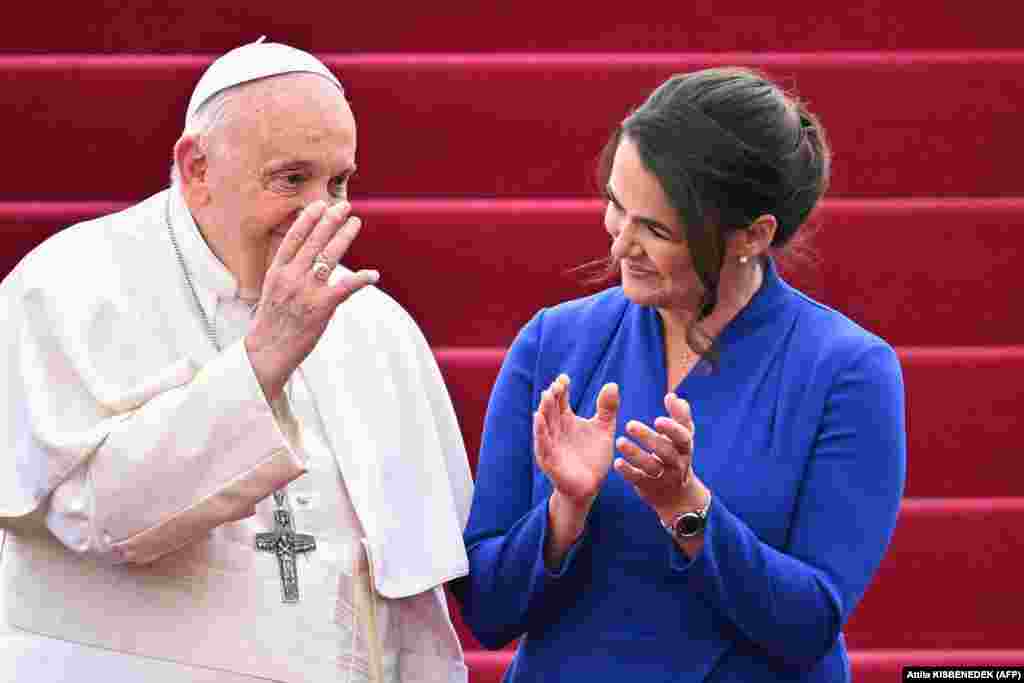 Pope Francis waves next to Hungary&#39;s President Katalin Novak during a farewell ceremony at Budapest International Airport on April 30, after his second visit to Hungary in less than two years came to an end.