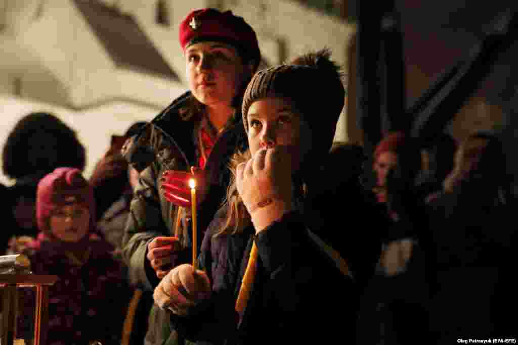 Young Ukrainians watch the December 10 ceremony outside the&nbsp;Saint Sophia Cathedral in freezing winter weather.&nbsp;
