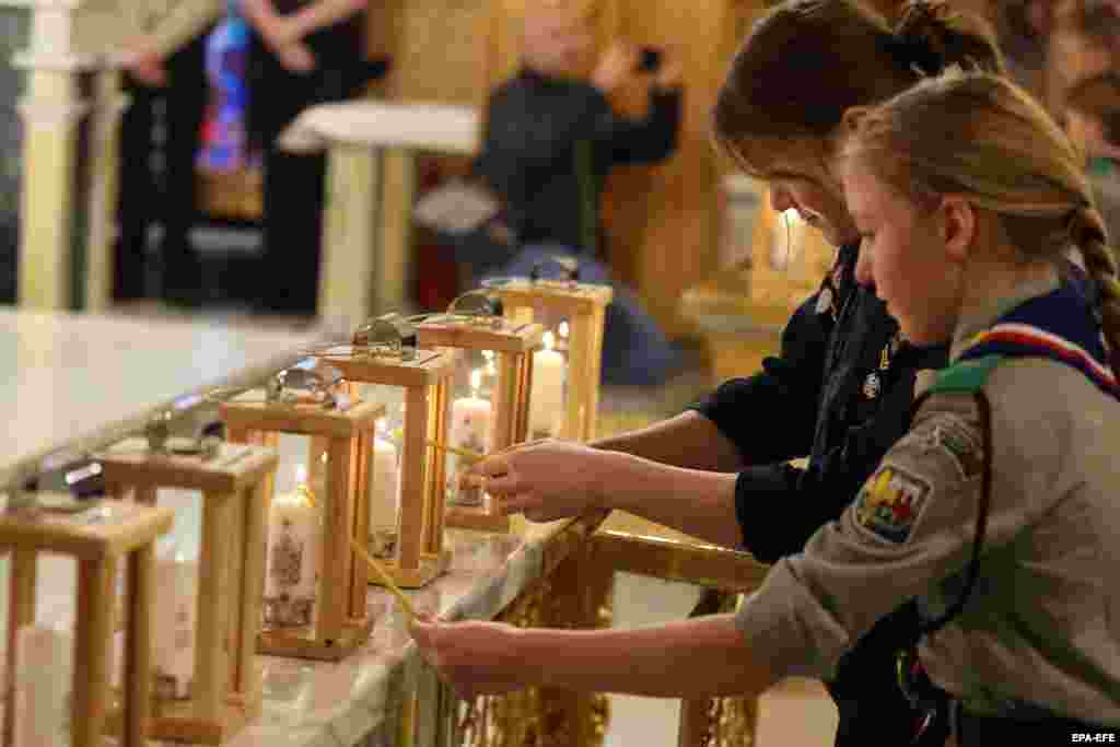 Slovakian and Polish girl scouts light their lanterns during a ceremony to distribute the peace light in southern Poland on December 10.