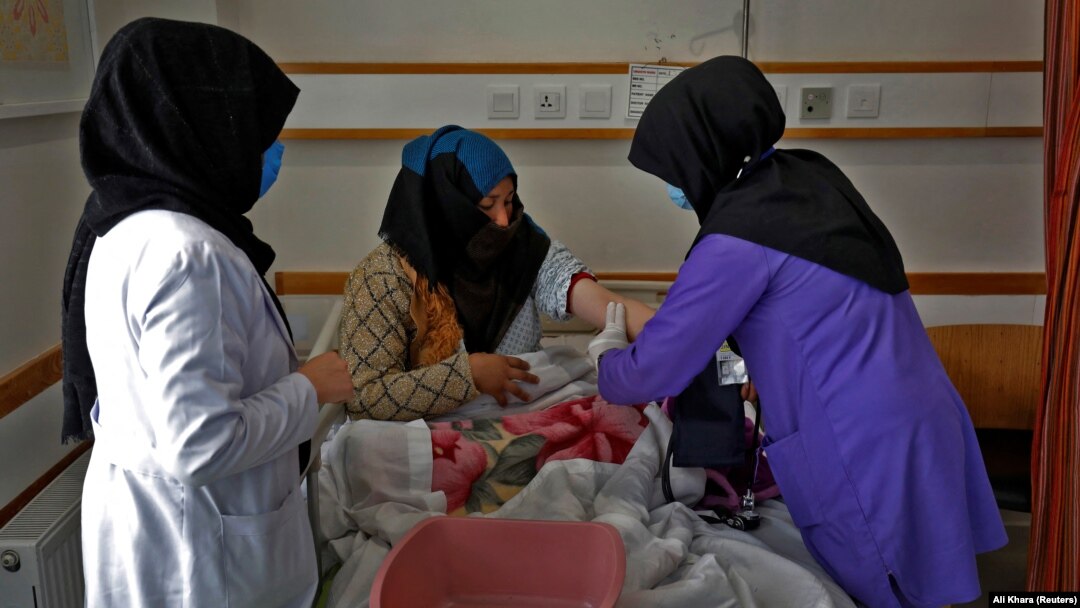 A trainee midwife examines a woman at a hospital in Bamiyan, Afghanistan, in March in a program spearheaded by the UN refugee agency with a local NGO.