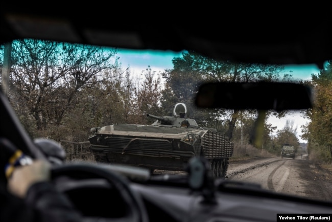 A Ukrainian soldier rides along a road in a BMP-1 armored fighting vehicle amid Russia's attack on Ukraine in the town of Avdiyivka on October 17.