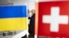 UKRAINE – Swiss President Alain Berset (C), seen behind a Ukrainian and Swiss flag, speaks with the Embassy staff of Switzerland, in Kyiv, Ukraine, 25 November 2023