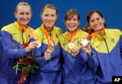 Ukrainian gold medalists (left to right) Olena Khomrova, Olha Kharlan, Halyna Pundik and Olha Zhovnir at the medal ceremony for the women's team saber event at the Beijing Olympics in August 2008