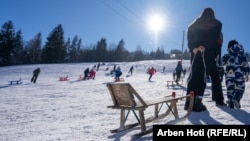 Një burrë duke tërhequr një sajë, në qendrën e skijimit në fshatin Bogë të Pejës.