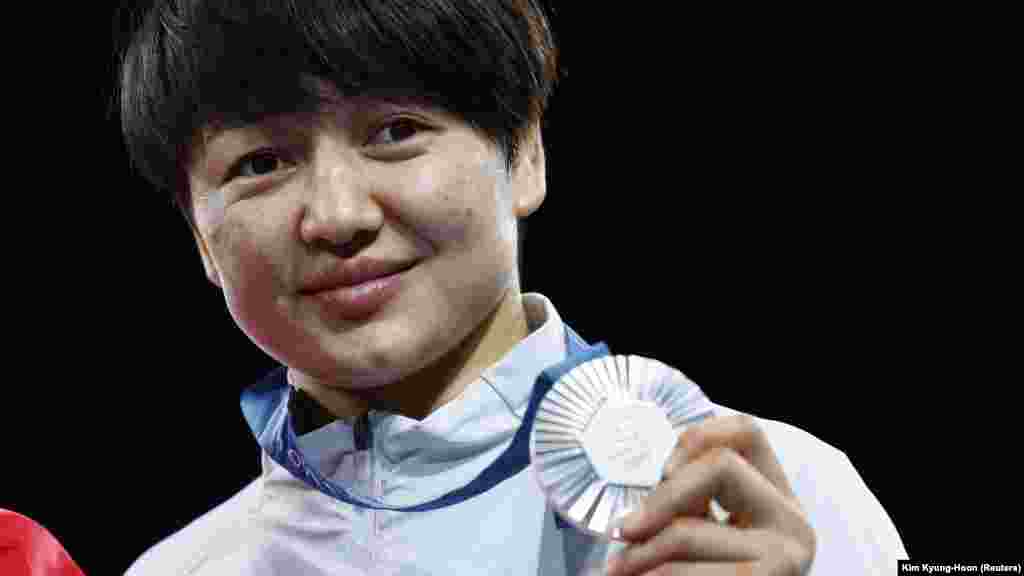 Meerim Zhumanazarova of Kyrgyzstan poses with her silver medal on August 6. Zhumanazarova won after competing in the women&#39;s freestyle 68-kilogram.