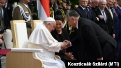 Hungarian Prime Minister Viktor Orban (right) greets Pope Francis sitting beside Hungarian President Katalin Novak at a reception held in Buda Castle on April 28.