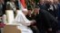 Hungarian Prime Minister Viktor Orban (right) greets Pope Francis sitting beside Hungarian President Katalin Novak at a reception held in Buda Castle on April 28.