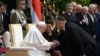 Hungarian Prime Minister Viktor Orban (right) greets Pope Francis, sitting beside Hungarian President Katalin Novak, at a reception held at Buda Castle on April 28.