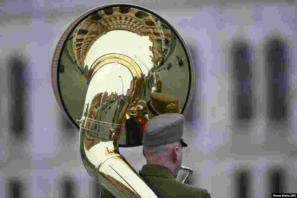 A member of the Hungarian military band plays in front of the parliament building in Budapest.