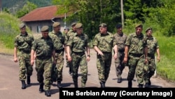 General Milan Mojsilovic (in green boots) visits Serbian Army units that were ordered to combat readiness over the situation in Kosovo in May.