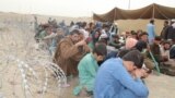 Afghan citizens wait at a holding center set up at the Chaman border crossing along the Pakistan-Afghanistan border in Pakistan&#39;s Balochistan Province on November 2.<br />
<br />
Thousands of Afghans are seeking to cross into Afghanistan following Islamabad&#39;s announcement that all undocumented immigrants in Pakistan must leave the country or face arrest.<br />
&nbsp;