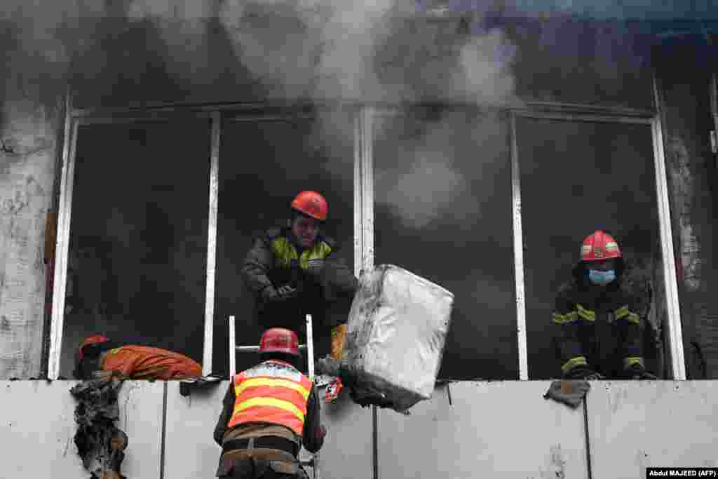 Firefighters douse a blaze at a shopping mall in Peshawar, Pakistan.