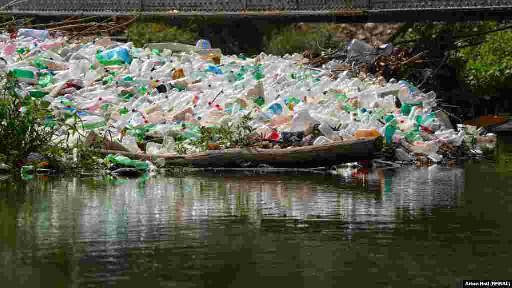 Plastic bottles, cans, and other floating waste are a stark reminder of Kosovo&#39;s waste crisis.