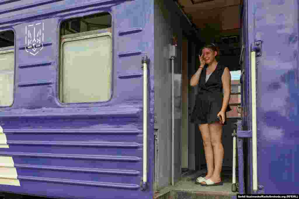 A young woman cries as she says goodbye to family members. &nbsp;