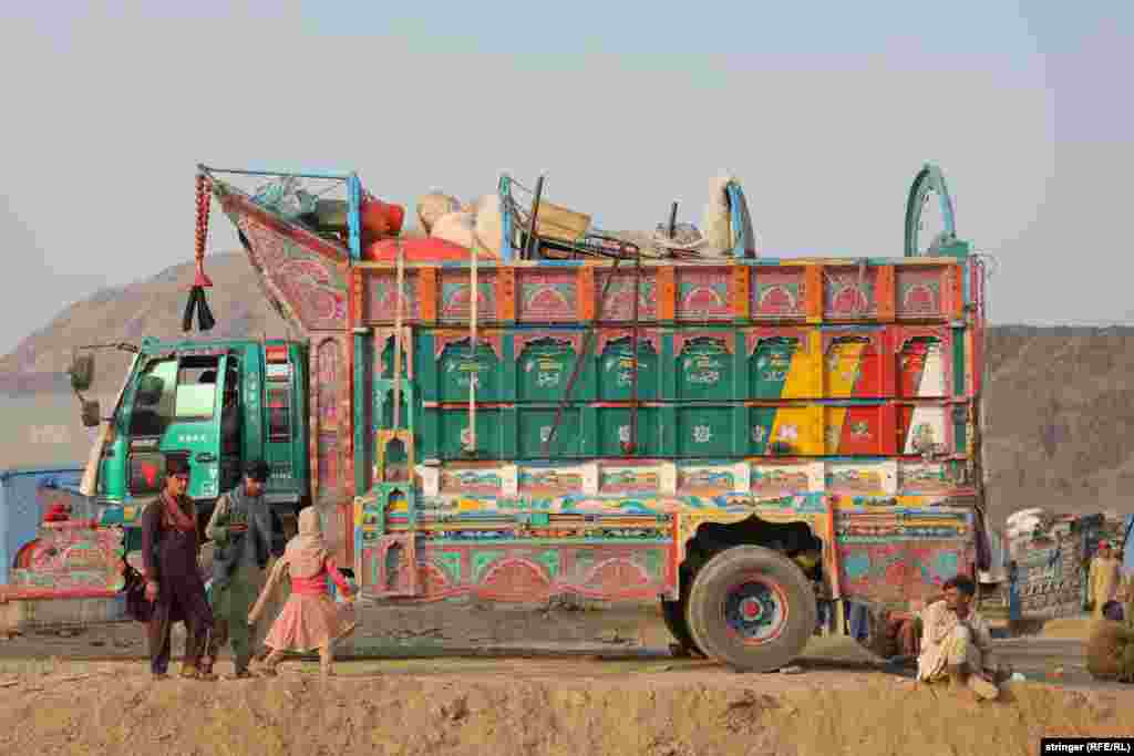 Another truck laden with personal items waits to be unloaded. &nbsp;